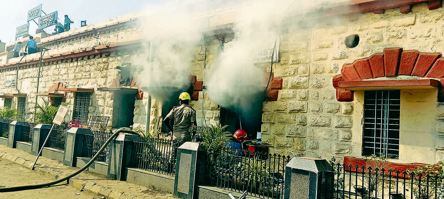 Jharsuguda News : झारसुगुड़ा स्टेशन में आग लगने से सिग्नल एंड टेलीकाॅम ऑफिस जलकर राख, तीन घंटे ठप रहा रेल यातायात- पुराने फुटओवरब्रिज पर काम करने के दौरान हाइटेंशन तार पर कुछ गिरने से तार टूटकर गिरने से हुई दुर्घटना- दिन के 11 बजे लगी आग, एक बजे आग पर काबू पाया गया, दो बजे से यातायात सामान्य हुआ- घटना के समय स्टेशन पर माैजूद सभी कर्मचारी व यात्री सुरक्षितडीसीएम ने कहा- जांच के बाद ही हो सकेगा नुकसान का आकलन(चित्र संख्या-09, 10 परिचय- आग बुझाते दमकल कर्मचारी तथा जलने से खाक सामान)प्रतिनिधि, झारसुगुड़ा झारसुगुड़ा स्टेशन में मंगलवार की सुबह आग लगने से सिग्नल एंड टेलीकाॅम ऑफिस जलकर राख हो गया. वहीं आग लगने की वजह से करीब तीन घंटे तक रेल यातायात बाधित रहा. हालांकि इस दुर्घटना में जानमाल के नुकसान होने की खबर नहीं है. घटना के बाद रेलवे के वरिष्ठ अधिकारियों ने पहुंचकर जांच शुरू कर दी है. चक्रधरपुर रेल मंडल के सीनियर डीसीएम आदित्य चौधरी ने बताया कि वायर में डिफेक्ट था, उसी कारण यह घटना घटी. जोरदार आवाज के साथ टूट कर गिरा ओवर हेड वायरजानकारी के अनुसार मंगलवार की सुबह करीब 11 बजे झारसुगुड़ा स्टेशन में स्थित एक पुराने फुटओवर ब्रिज पर काम चल रहा था. तभी रेलवे के ओवर हेड वायर (हाई अटेंशन 25000 वाट) पर कुछ सामग्री के गिरने से जोरदार आवाज के साथ वायर टूट कर नीचे गिर गया . नीचे जहां वायर गिरा वहां स्टेशन का टेलीफोन व सिग्नल का केबल गुजरा है, जिससे वायर के गिरते ही उसमें आग लग गयी और यहां से केबल के शार्ट होते ही टेलिफोन एंड सिग्नल के मुख्य ऑफिस में शार्ट सर्किट हुआ और केबल में आग लग गयी. आग लगने से धुआं फैलने लगा और देखते ही देखते पूरे स्टेशन में धुंए का गुबार छा गया. इसकी सूचना मिलते ही आनन-फानन आरपीएफ, जीआरपी व रेल कर्मचारी प्लेटफार्म नंबर एक से यात्रियों व लोगों को बाहर निकाला और दमकल विभाग को सूचित किया. दमकल की दो गाड़ी स्टेशन पहुंची और आग बुझाने में लगी. करीब दो के ढाई घंटे की मशक्कत के बाद आग पर काबू पाया जा सका. करीब दिन के दो बजे से रेल यातायात सामान्य हुआ. सात से अधिक ऑफिस आये चपेट मेंआग से इतना ज्यादा काला धुआं आ रहा था की दमकल विभाग के कर्मचारी भी अंदर नहीं घुस पा रहे थे. बाद में विभाग की स्पेशल टीम के सदस्य मास्क व सिलेंडर लेकर घुसने का प्रयास किया. किसी तरह आग पर पानी की बौछार कर काबू पाया गया. वहीं इस ऑफिस में लगी आग के साथ इससे सटे उपस्टेशन मैनेजर, पूछताछ कार्यालय सहित सात से अधिक ऑफिस भी चपेट में आये हैं. लेकिन, इससे कितने का नुकसान हुआ है, इसका पता नहीं चल पाया है. झारसुगुड़ा स्टेशन के सिग्नल व टेलीकाॅम ऑफिस में आग लगते है तुरंत बिजली की सप्लाई को बंद करवाया गया. आग लगने से यह ऑफिस पूरी तरह से जल गया जिससे पूरी संचार व्यवस्था ठप्प हो गयी. इसके चलते पूर्वाह्न 11 बजे से झारसुगुड़ा रेलवे जंक्शन से गाड़ियों की आवाजाही को रोक दिया गया था. स्टेशन में आग की सूचना पाकर टाउन पुलिस के अधिकारी घटनास्थल पहुंचे व यहां व्यवस्था बनाने में रेल पुलिस की मदद की. वहीं, घटना की सूचना पाकर रेलवे की सेफ्टी यूनिट की टीम घटना स्थल पहुंची व टूटे हाइ टेंशन वायर को फिर से जोड़ा. चक्रधरपुर रेल मंडल के सीनियर डीसीएम आदित्य चौधरी ने इस संबंध में बताया कि वायर में डिफेक्ट था. उसी कारण यह घटना घटी. इसकी विभागीय जांच की जायेगी. उसके बाद सच्चाई सामने आयेगी. उन्होंने कहा कि इस घटना में कितना नुकसान हुआ है, यह अभी नहीं कह सकते. जांच के बाद ही इस संबंध में कुछ कहा जा सकेगा. वहीं, उक्त घटना के बाद अपराह्न एक बजे स्थिति सामान्य हुई और दो बजे से इस मार्ग पर रेल यातायात सामान्य हुआ.झारसुगुड़ा स्टेशन में आग लगने से सिग्नल एंड टेलीकाॅम ऑफिस जलकर राख, तीन घंटे ठप रहा रेल यातायात- पुराने फुटओवरब्रिज पर काम करने के दौरान हाइटेंशन तार पर कुछ गिरने से तार टूटकर गिरने से हुई दुर्घटना- दिन के 11 बजे लगी आग, एक बजे आग पर काबू पाया गया, दो बजे से यातायात सामान्य हुआ- घटना के समय स्टेशन पर माैजूद सभी कर्मचारी व यात्री सुरक्षितडीसीएम ने कहा- जांच के बाद ही हो सकेगा नुकसान का आकलन(चित्र संख्या-09, 10 परिचय- आग बुझाते दमकल कर्मचारी तथा जलने से खाक सामान)प्रतिनिधि, झारसुगुड़ा झारसुगुड़ा स्टेशन में मंगलवार की सुबह आग लगने से सिग्नल एंड टेलीकाॅम ऑफिस जलकर राख हो गया. वहीं आग लगने की वजह से करीब तीन घंटे तक रेल यातायात बाधित रहा. हालांकि इस दुर्घटना में जानमाल के नुकसान होने की खबर नहीं है. घटना के बाद रेलवे के वरिष्ठ अधिकारियों ने पहुंचकर जांच शुरू कर दी है. चक्रधरपुर रेल मंडल के सीनियर डीसीएम आदित्य चौधरी ने बताया कि वायर में डिफेक्ट था, उसी