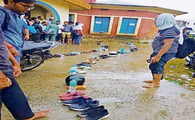 आवेदन जमा करने को लाइन में लगाये जा रहे जूते, चप्पल, पानी बोतल और हेलमेट