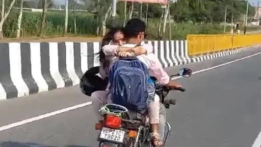 हापुड़ में पति-पत्नी चलती बाइक पर रोमांस करते आए नजर, टंकी पर बैठ पति को गले लगा रही महिला, वीडियो वायरल