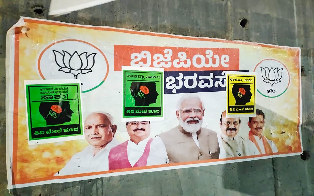 Karnataka Assembly Elections: कर्नाटक में पोस्टर वॉर, कांग्रेस का BJP के खिलाफ ‘कान पर फूल’ अभियान शुरू