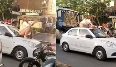 वाराणसी: बीच सड़क पर विदेशी महिला ने कार की छत पर बैठकर किया ड्रामा, वीडियो हुआ वायरल, थाने ले गई पुलिस