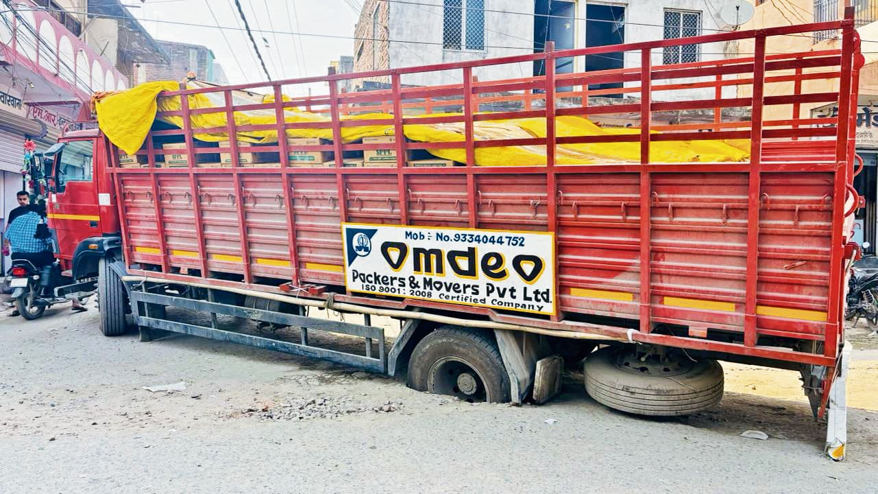 सड़क के बीच धंसा दवा लोड ट्रक का चक्का, यातायात हुआ बाधित