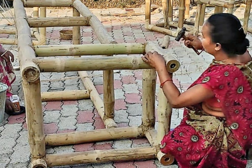 Woman making art piece from bamboo