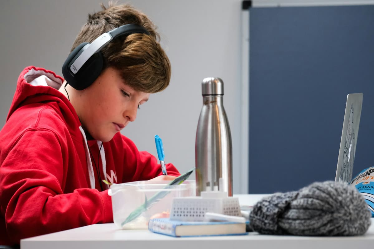 kid in red hoodie studying kid in red hoodie studying