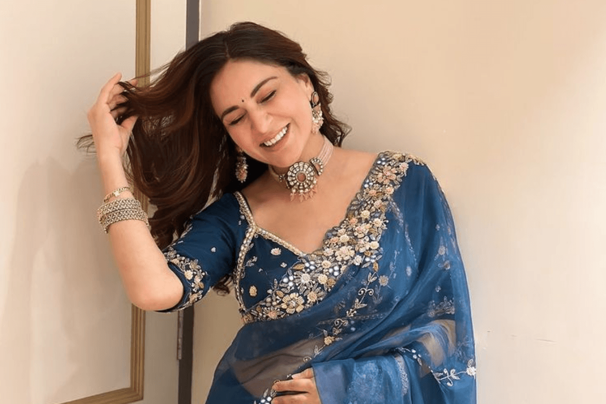 Traditional Teej photoshoot of woman laughing in ethnic dress.