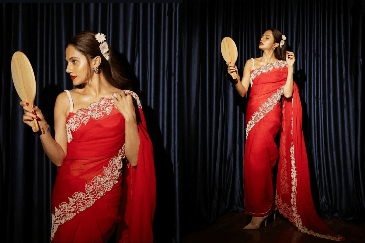 Teej special photoshoot of woman admiring herself in mirror wearing saree.