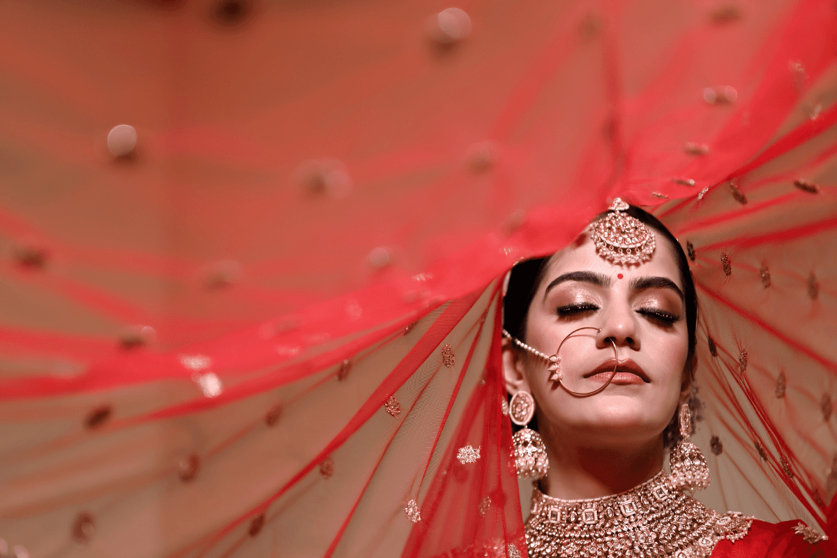 Elegant woman with Ghoonghat pose in saree for Teej photoshoot idea.