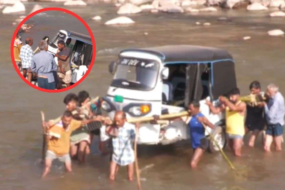 Villagers carry an Auto Rickshaw