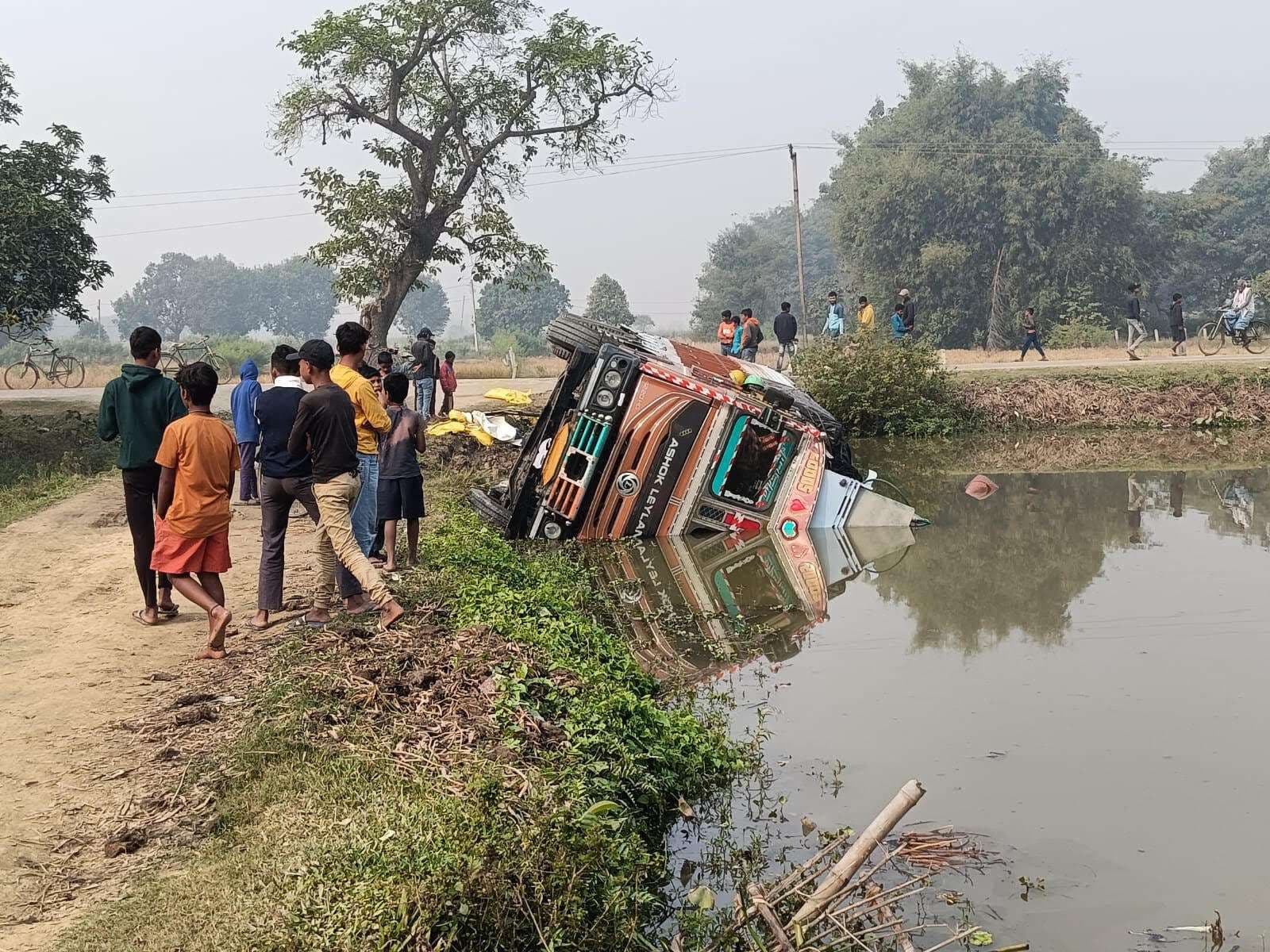 Madhubani News : पुलिस के पीछा करने पर सड़क किनारे तालाब में पलटा ट्रक