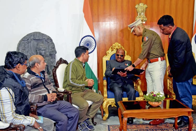 मतदाता पंजीकरण स्थानांतरित करने के लिए दस्तखत करते राज्यपाल.