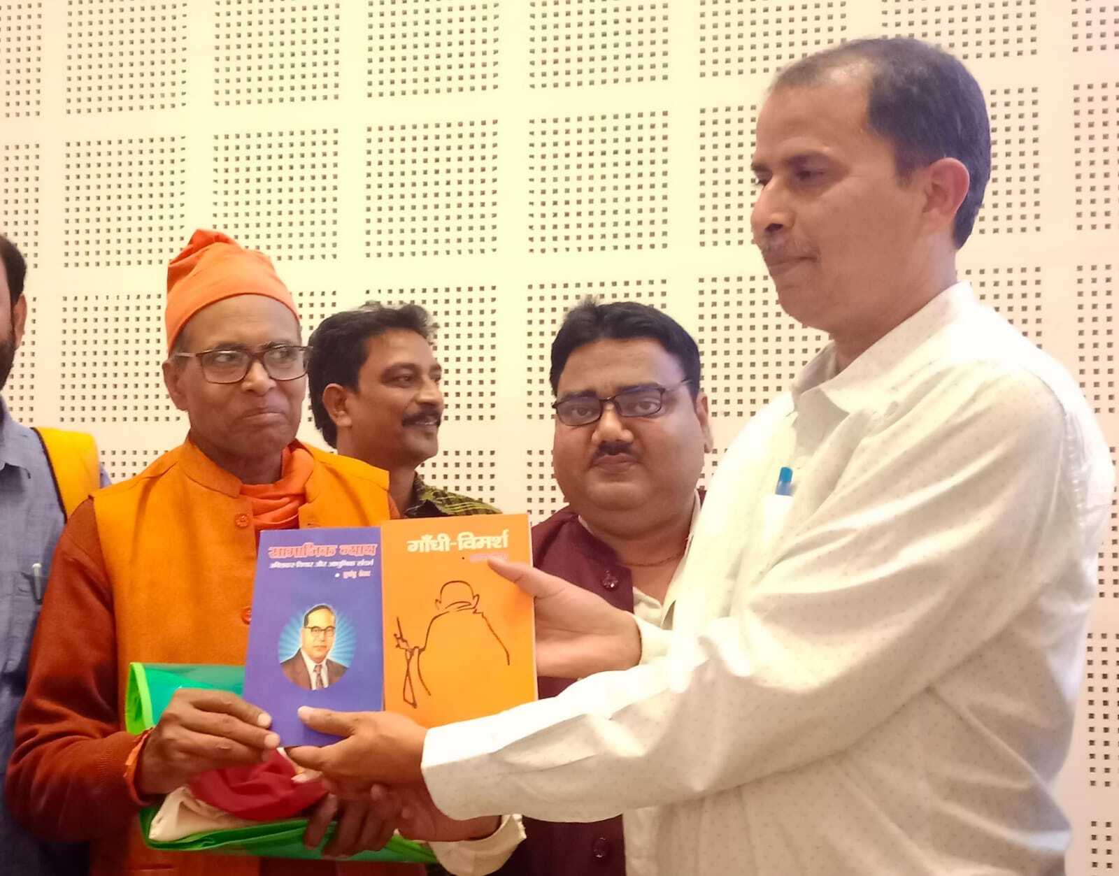 दिल्ली विश्वविद्यालय के प्रोफेसर को पुस्तक भेंट