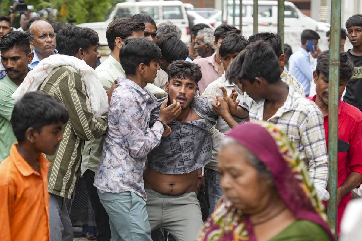 Relatives of a victim of the Air India plane crash mourn at a hospital, in Ahmedabad